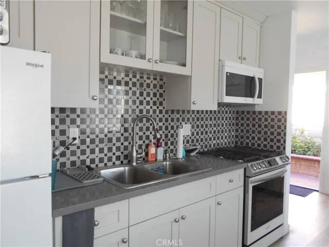 SParkling kitchen with refrigerator, range, miccrowave