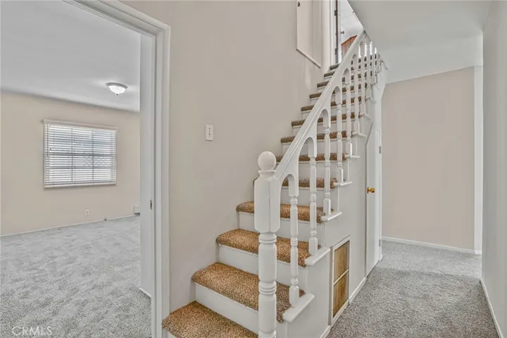 Staircase to 2nd floor with peekaboo view of bedroom 3