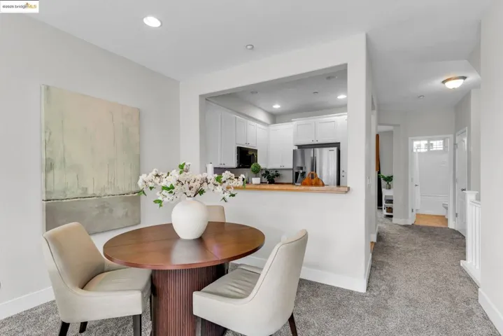 Dining area with recessed lighting and light carpet