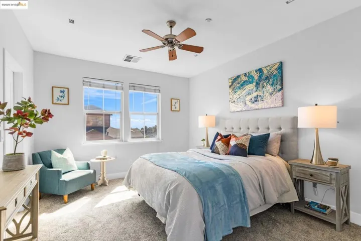 Carpeted bedroom featuring ceiling fan and baseboards