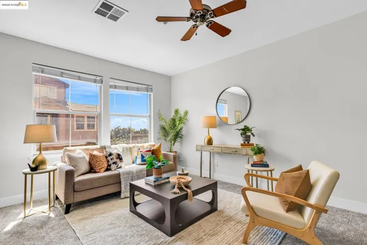 Carpeted living room with baseboards and ceiling fan