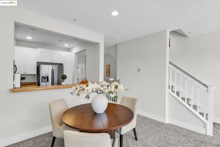 Dining space with recessed lighting, stairway, and light colored carpet