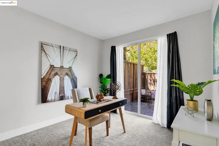 Office space with light carpet and baseboards