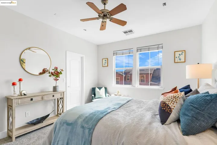 Bedroom with a ceiling fan and carpet