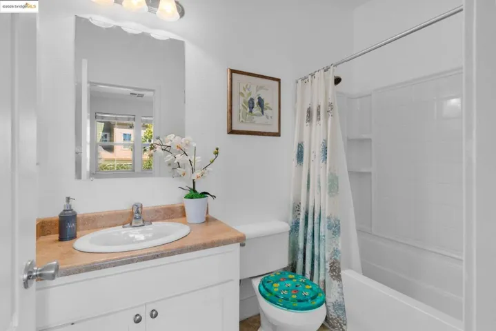 Full bath with vanity and shower / bath combo with shower curtain