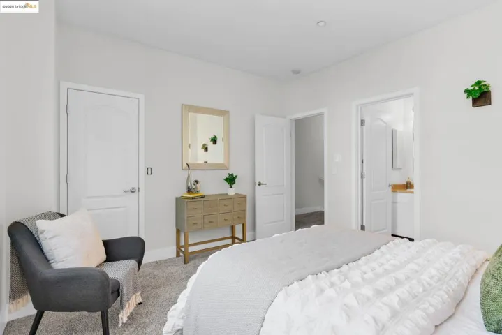 Carpeted bedroom with baseboards and connected bathroom