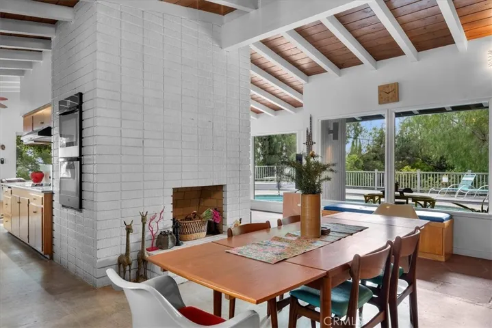 Dining room with kitchen and fireplace in view