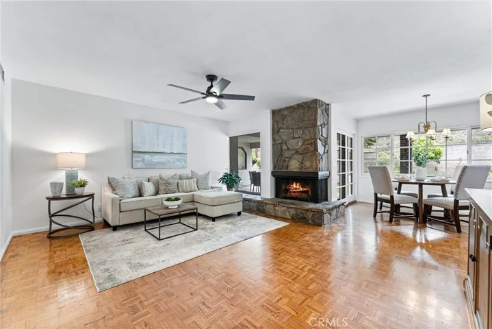 The sunny and bright family room has beautiful parquet wood floors.  And easy access to the kitchen dining area