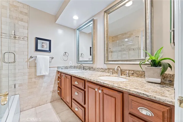 This bathroom is in the first part of the hallway.  Beautiful, dual sink, vanity and a glass enclosed bath tub.