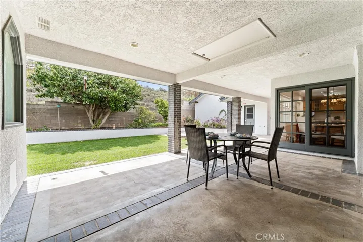 Time to step outside to the large, covered patio. The sliding door goes into the kitchen, dining area and family room.