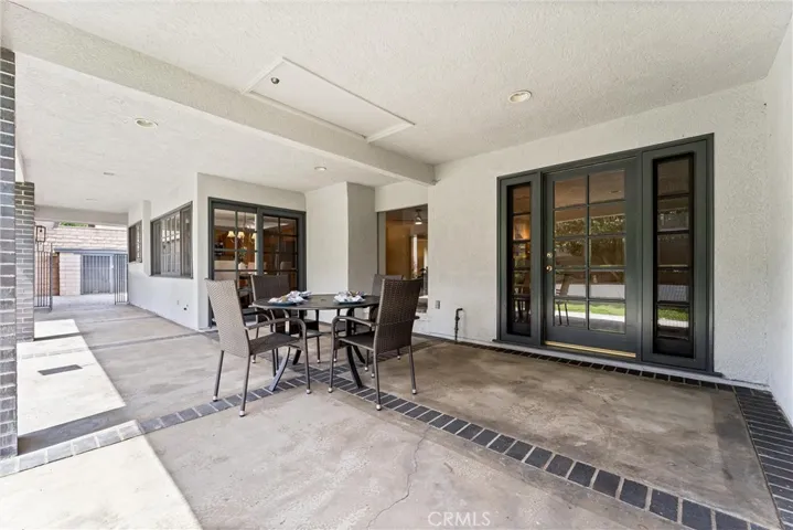From this patio view you see not only the sliding door to the kitchen, but also the French door to the primary suite.