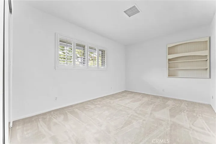 Now we are at the second of the secondary bedrooms.  Again with planation shutters and built in shelves.