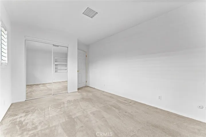 The same first of three bedrooms has new mirrored closet doors.