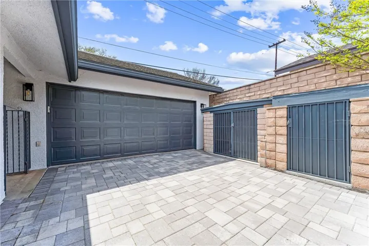 Beautiful lock pavers of the long driveway and two custom outdoor storage areas.  The garage is nearly 500 square feet and two of the walls are done with built in storage shelves.  The other side has a built work bench. One more detail is the fully decked attic for storage.