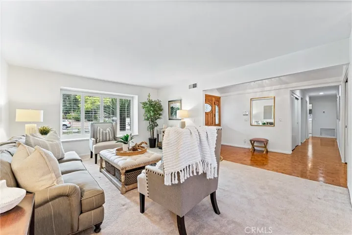 Living room is to the tight from the front entry. Tons of natural light.  Plus plantation shuters.
