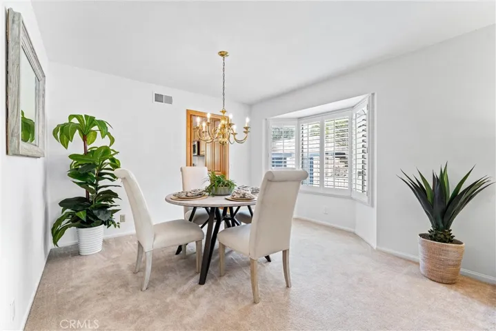 The dining room has a large bay window allowing for natural light  And a butler's door to the kitchen