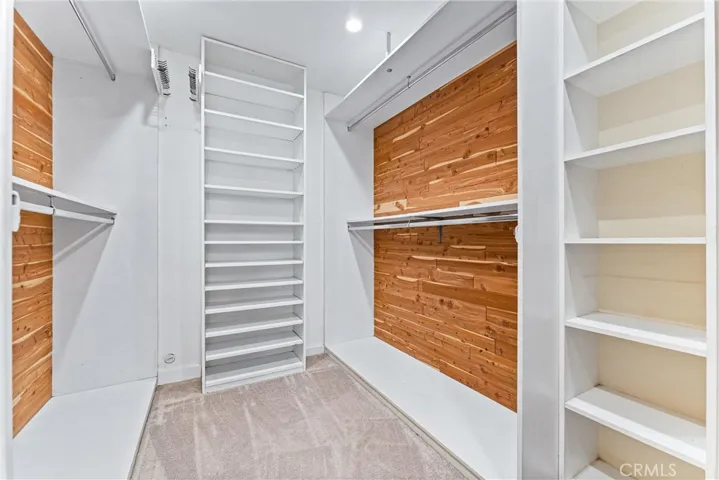 From the left of the bathroom entry is this large walk-in closed with built-in storage walls lined with cedar.