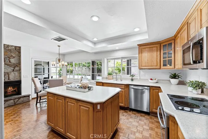 From the kitchen you have a quick shot of the wrap around family room fireplace and access to the sliding door to the covered patio.