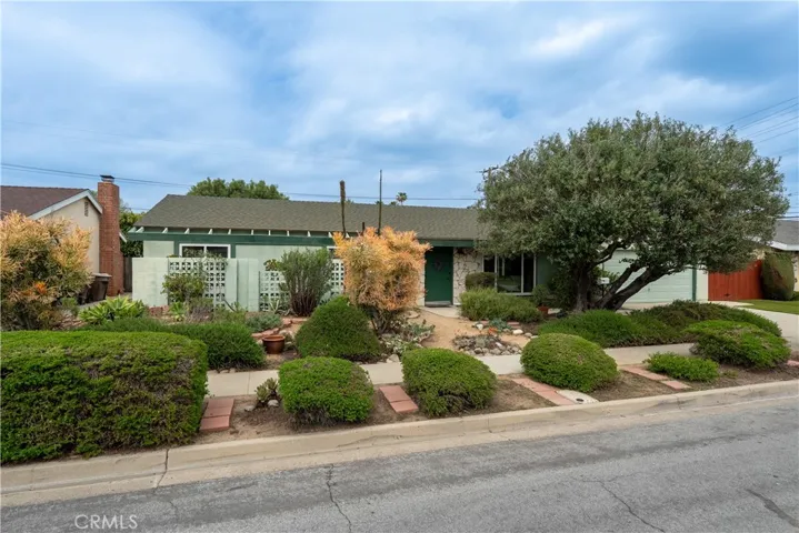 Low maintenance, water-conserving xeriscape (fancy term for drought-tolerant landscaping ;-) The mid-century cinderblock screens provide some privacy to the front bedrooms.