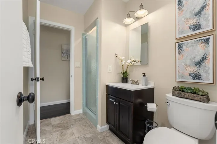 The secondary bathroom viewed from the laundry with the hallway ahead.