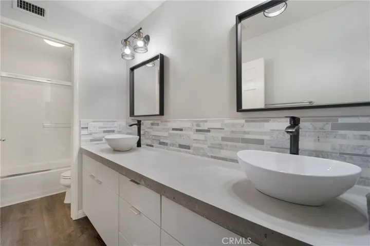 En suite remodeled bath has dual vanities.