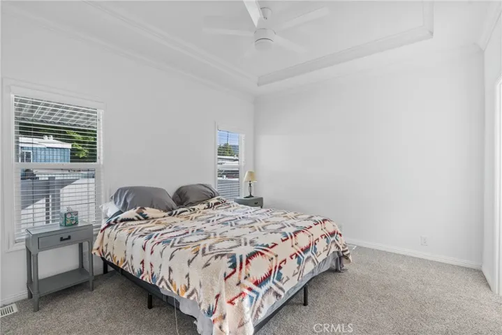 Primary bedroom coffered ceiling crown moulding throughout