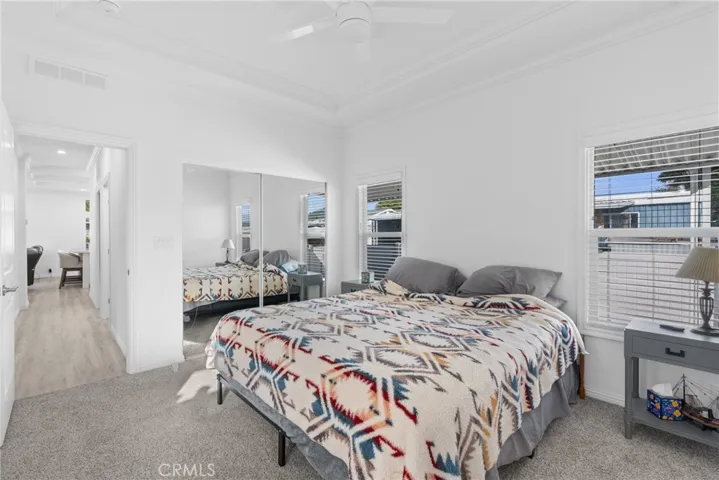 Primary bedroom mirrored walk in closet