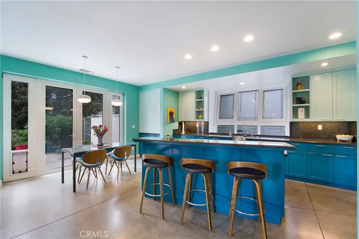 Gourmet kitchen with center island and 6 burner cook top as well as sunny nook.