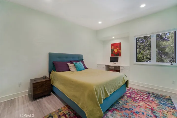 A secondary bedroom with built in study space.