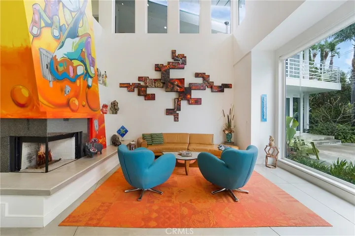 Hand crafted glass art also graces the fireplace. The art piece above the couch graces this home and is included.