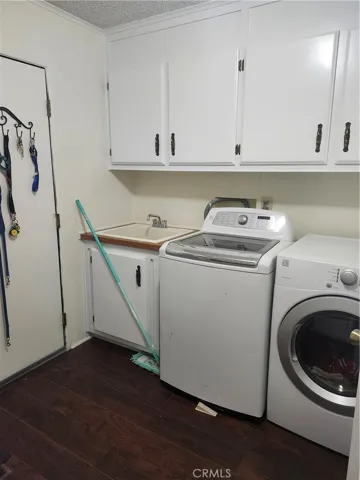 Laundry room with washer and dryer that stay