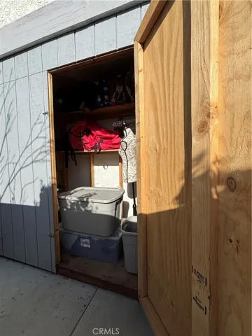 Owners added storage on the side of the house, and newly paved concrete.