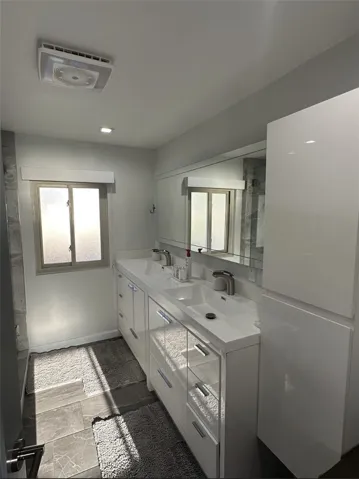 Remodeled upstairs bathroom with double sink.