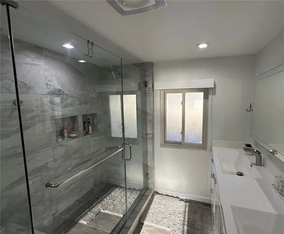 Remodeled upstairs bathroom with a new shower.
