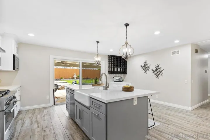 Kitchen sliders lead directly to El Fresco dining and pool/yard. Please note the custom wine/coffee bar. Great gathering space