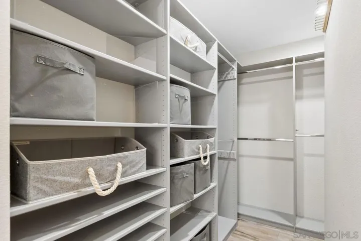 Primary walk-in closet with built in custom storage