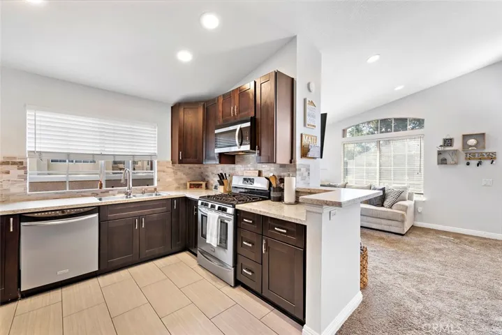 Your Open floorplan kitchen with Granite Counter Tops, Stainless Steel Appliances ,Recessed lighting, Tile flooring and plenty of cabinet space.  It will bring the Chef out of you to create those awesome meals.