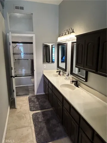 primary bathroom, shower, Tile flooring ,dual sinks, dual custom mirrors, extra long counter top ,with extra cabinetry.