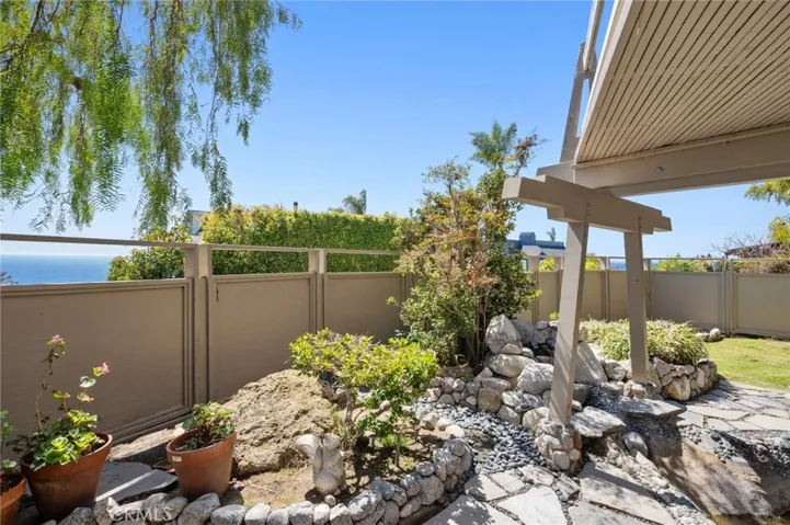 A private backyard offers a serene retreat, while the driveway provides ample guest parking.