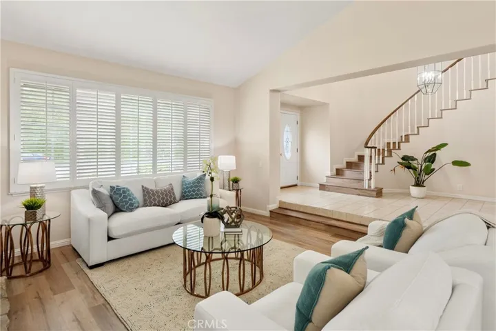 Beautiful living room with shutters, fireplace and loads of natural light
