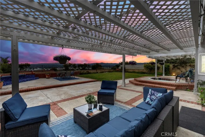 Spacious backyard with bubbling spa to "wind down" after a hard day or simply sit outside and enjoy an everchanging panoramic view. It's beautiful at night with twinkling lights from homes in the distance