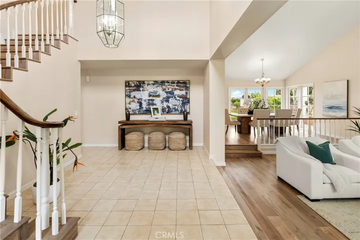 Double door entry into the foyer with two story ceilings.