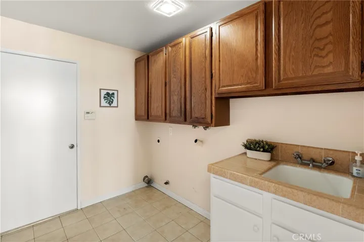 Inside laundry on main floor with sink, cabinets and direct access to 3 car garage