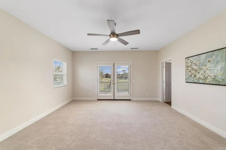 Primary bedroom with an oversized walk-in closet complete with built-in organizers for easy storage.