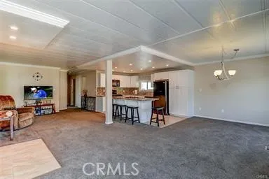 FRONT ROOM, LOOKING INTO KITCHEN AREA