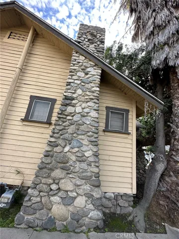 The fireplace that is part of this river rock chimney is covered inside by drywall.