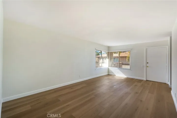 Another View of Living Room looking to Front Door and Windows