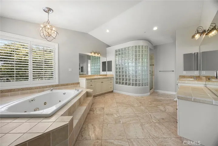 PRIMARY BATHROOM WITH TWO VANITY STATIONS, JETTED SOAKING TUB AND LARGE SHOWER