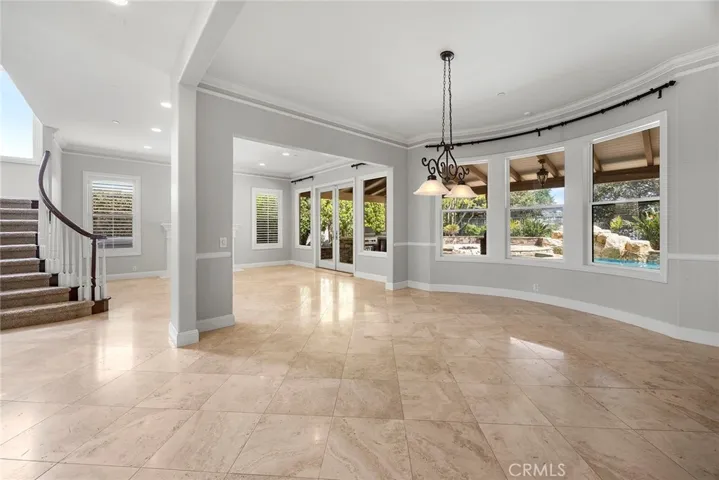 DINING AREA NEXT TO THE LIVING AREA BOTH OVERLOOKING THE PATIO, POOL AND SPA
