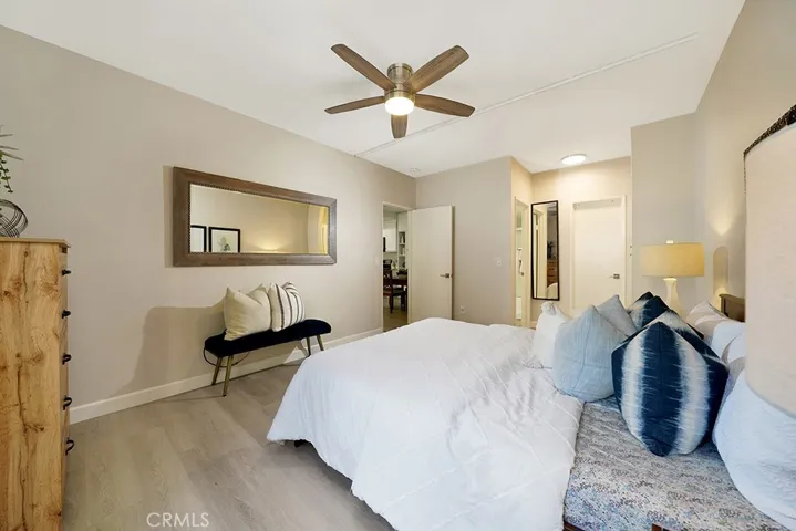 Bedroom with ceiling fan and en suite bathroom with quartz countertops and tub/shower